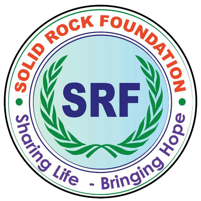 The image is a logo for the Solid Rock Foundation, featuring the text "SOLID ROCK FOUNDATION" in orange, "SRF" in purple, ...